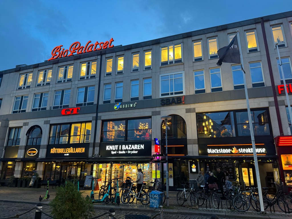 A street scene in Göteborg Sweden, a four story office building with Swedish company names.