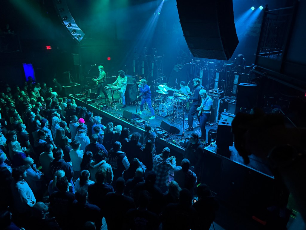 A five-piece punk band, Spiritual Cramp, rocks out in front of a sold out crowd at the storied 9:30 Club in Washington DC